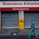 A medical worker walks by a hospital in a Brooklyn, NY neighborhood that saw a significant number of covid-19 cases early on in the pandemic on September 14, 2020.